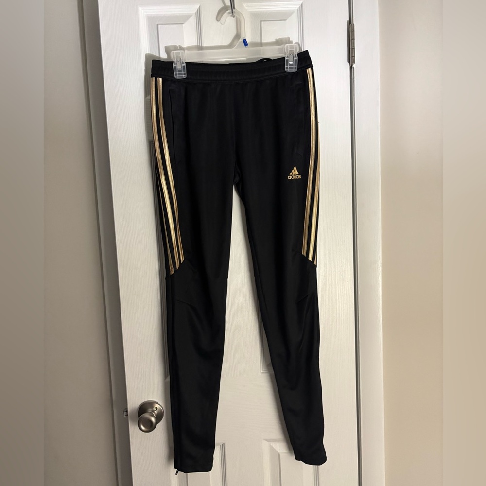 Black and gold Adidas track pants